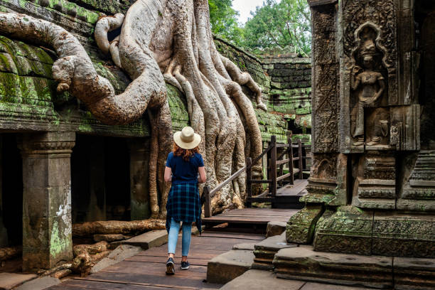 viaggiatore che esplora antiche rovine del tempio di ta prohm ad angkor, siem reap, cambogia - angkor wat buddhism cambodia tourism foto e immagini stock
