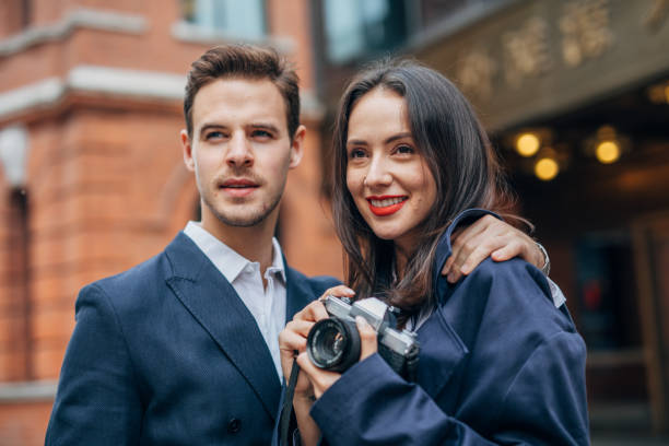 istock Couple with camera on the street 1153879787