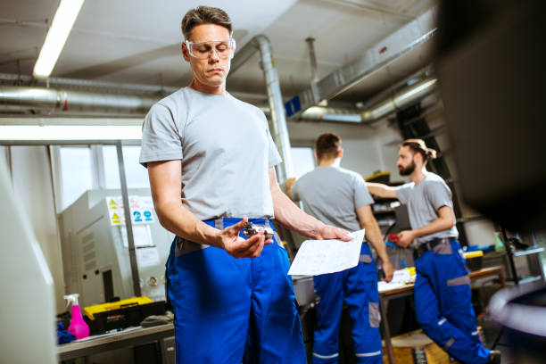 istock Engineer and workers doing their quality control in factory 1153879827