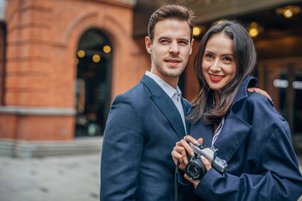 istock Charming couple with camera in city 1153879967