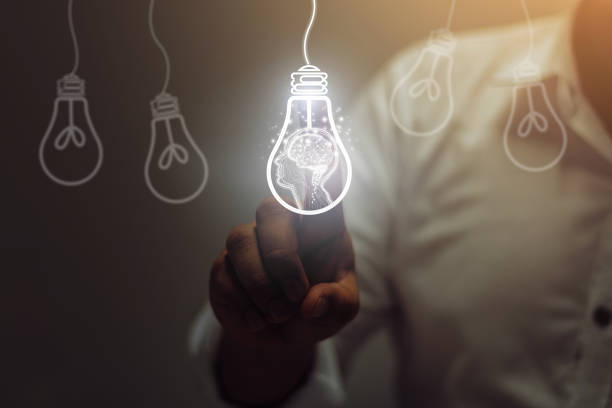 idea Businessman touching light bulbs. ideas of new ideas with innovative technology and creativity. genius stock pictures, royalty-free photos & images