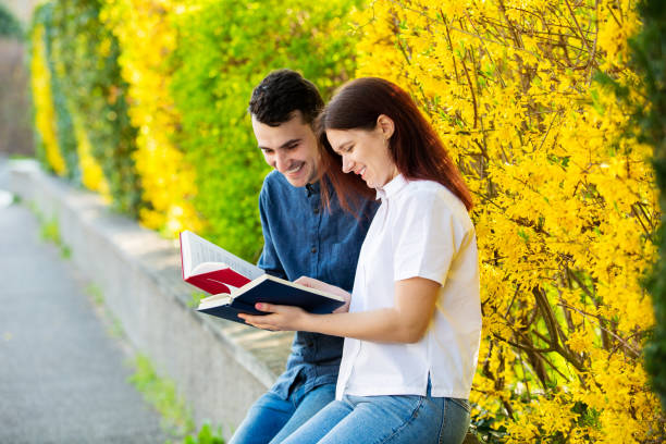 istock Students learning for exam together in a city park 1153884646