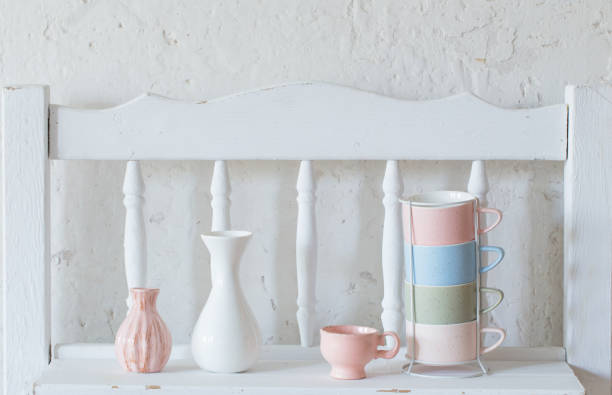 cups and vase  on vintage white shelf
