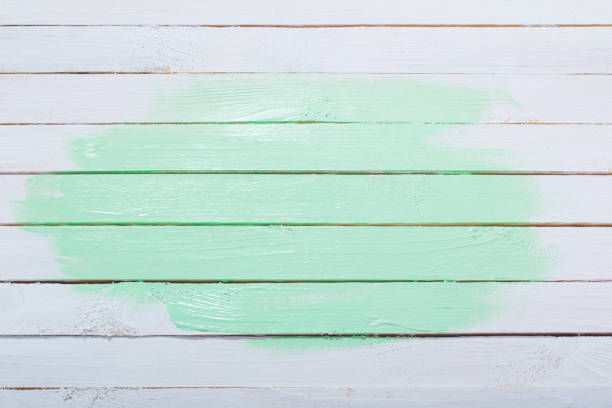 istock white and green painted wooden background 1153886617