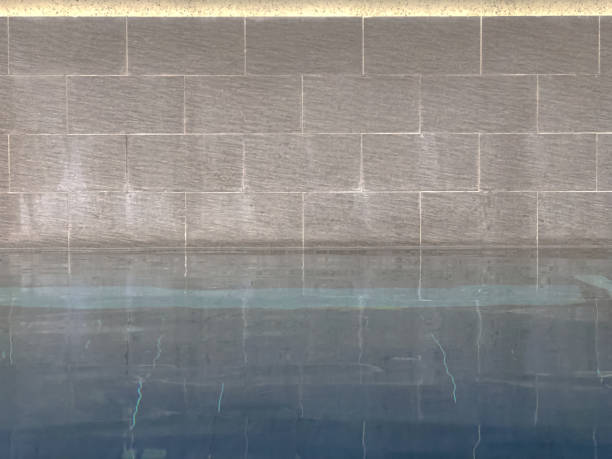 istock close up of swimming pool with brick wall 1153886895