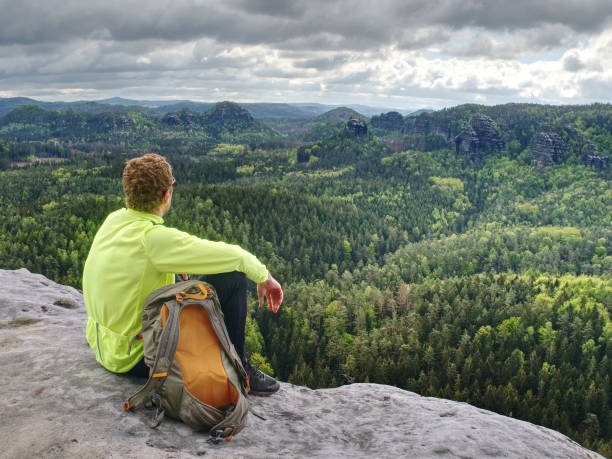 istock Spring rocky mountains. Hiker with backpack stand on rock 1153889280