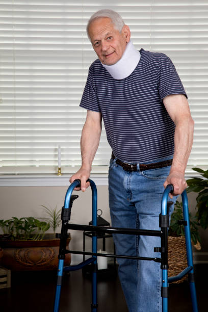 istock Senior man at home with neck brace using a walker looking at camera 1153891999