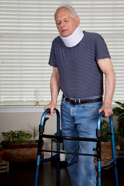istock Senior man at home with neck brace in obvious pain using a walker 1153892004