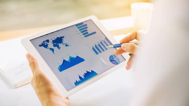 istock businessman working on project for analyzing company financial report balance statement with documents graphics at modern office space. Concept picture of business,economy, market,money and tax. 1153892274