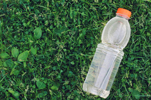 istock bottle of clean drinking water on a grass background, top view. 1153892393