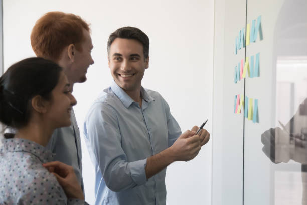istock Multiracial work team discuss idea presented on strikers in office 1153894583