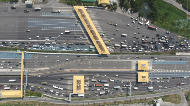 Over Head Shot of  Expressway Toll Gate with Many Vehicles Passing Through and Pay Fee, Aerial Video