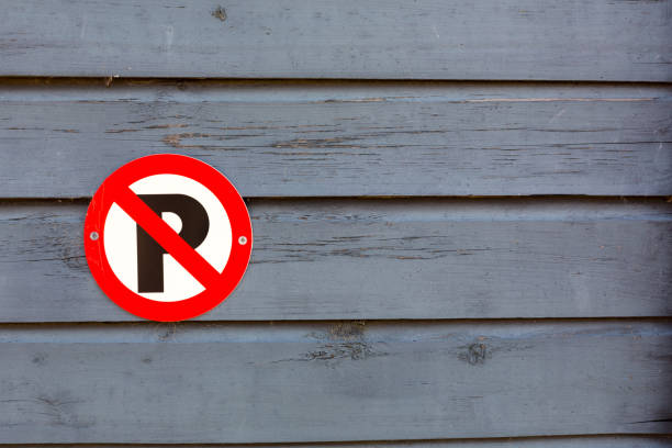 istock ´No Parking´sign on a wooden grunge paint surface with copy space. 1153896915