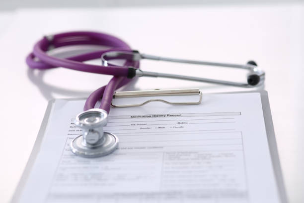 istock Medication history record form lying on table with stethoscope and silver pen. Medicine or pharmacy concept. Medical tools at doctor working table 1153898361