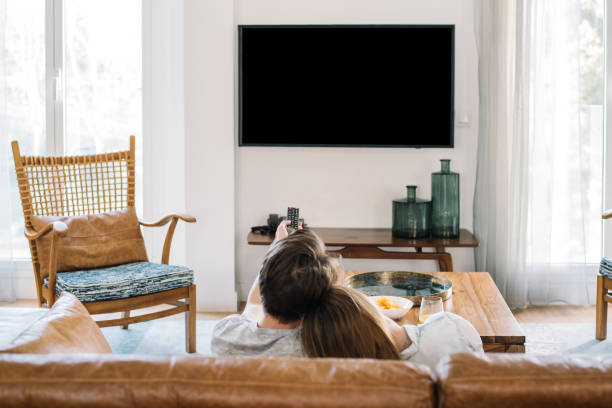 istock Happy couple watching tv 1153900653