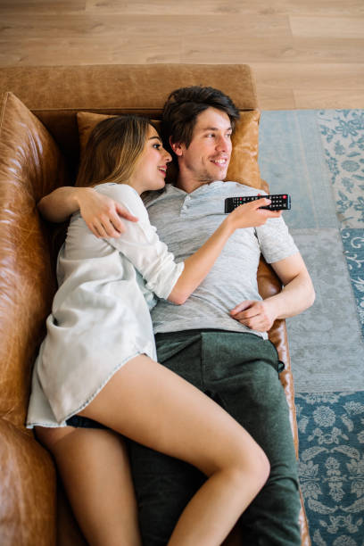 istock Happy couple watching tv 1153900663
