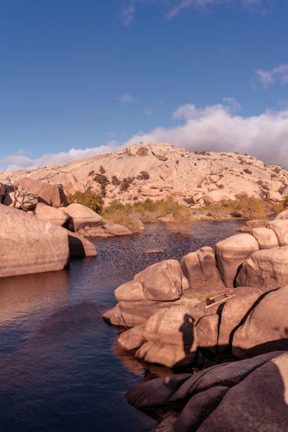 istock Oasis lake in desert with wild rocks around. 1153903253