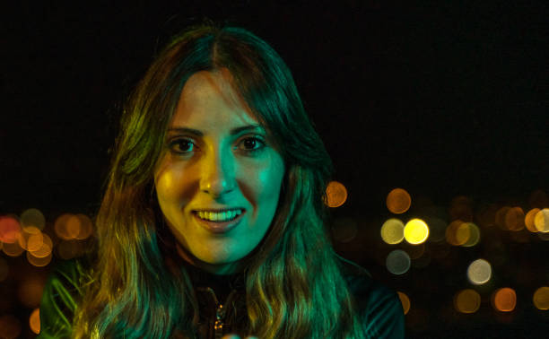istock Young trendy woman at night 1153903536