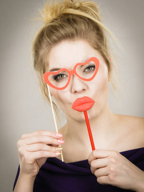 istock woman holds carnival accessories on stick 1153904701
