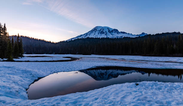 istock Partially frozen Reflection Lake after sunset on Mt Rainier, WA 1153906339