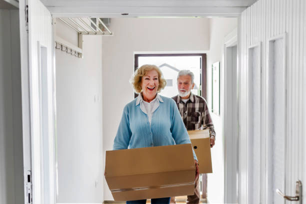 istock Senior couple carrying boxes 1153913959