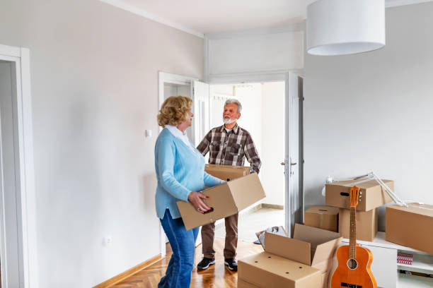 istock Couple with Moving Boxes in New Home 1153914105