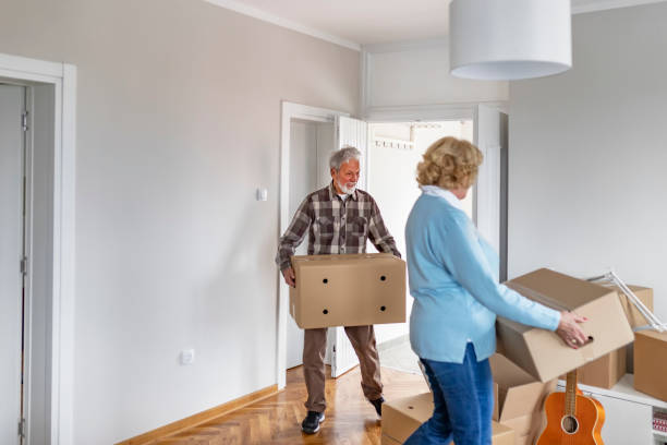 istock Couple with Moving Boxes in New Home 1153914114