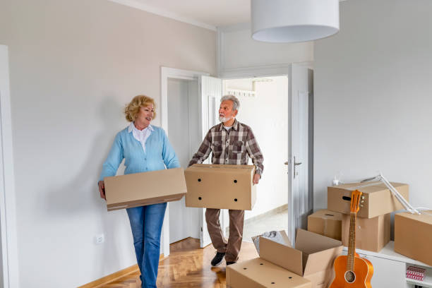 istock Couple with Moving Boxes in New Home 1153914183