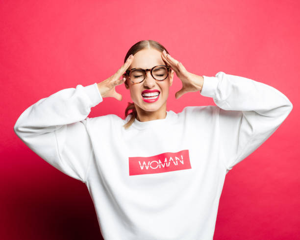 istock Frustrated woman screaming against pink background 1153921079