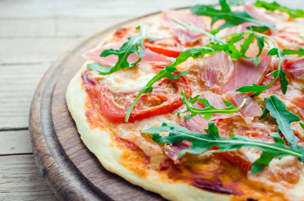 istock Italian pizza with prosciutto and arugula 1153922609