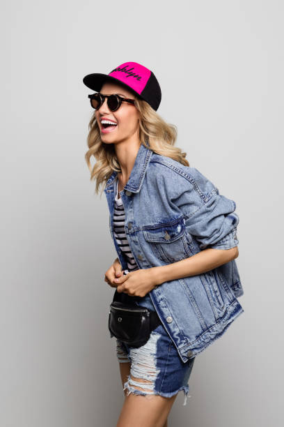 istock Laughing young woman wearing denim jacket 1153924453