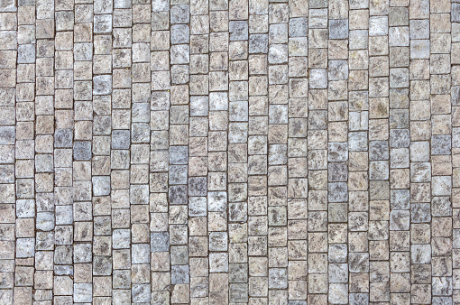 An old stoneblock pavement cobbled with square granite blocks.