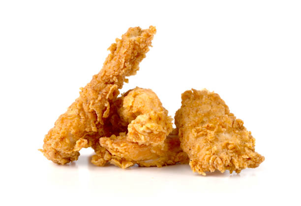 istock Fried chicken fillets on a white background. Fried chicken nuggets close-up. 1153924612