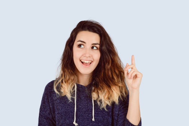 istock Young woman pointing 1153927552