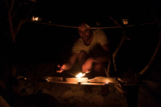 istock Man lighting candles in the night 1153928381