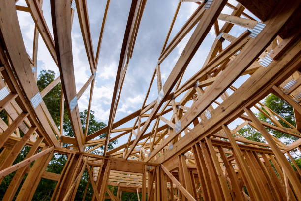 istock Looking up new construction beams under a clear blue sky with sunlight 1153928845