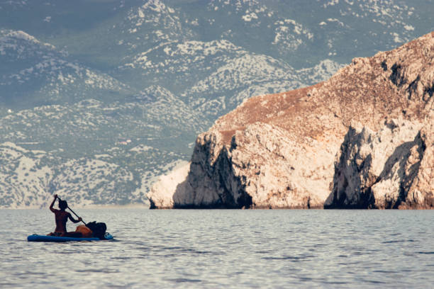 istock Woman paddling over sea 1153928930