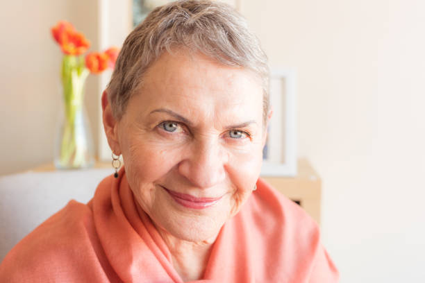 istock Attractive older woman with orange shawl 1153929776