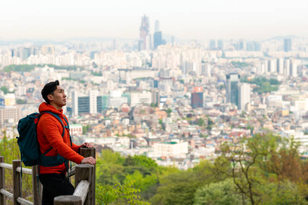 Backpacker is enjoying weekend in nature hiking in Seoul Korea.