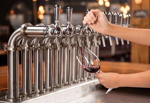 Wine being poured from a keg tap