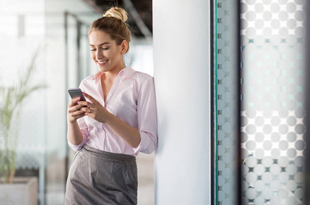 istock Business woman using smartphone in office 1153931230