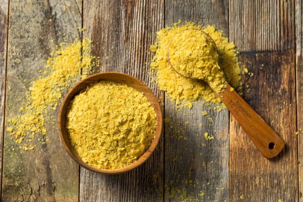 Raw Yellow Organic Nutritional Yeast Raw Yellow Organic Nutritional Yeast in a Bowl yeast stock pictures, royalty-free photos & images