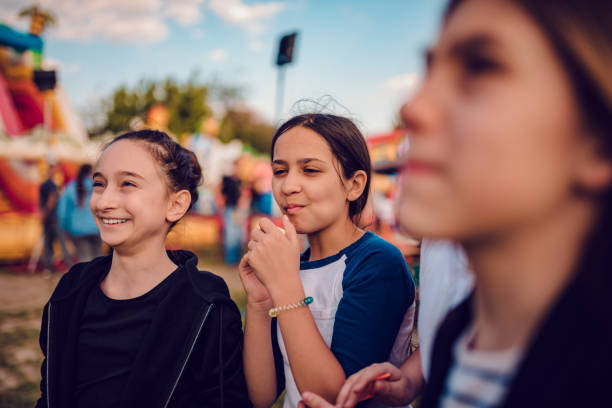 istock Friends hang out at amusement park 1153932361