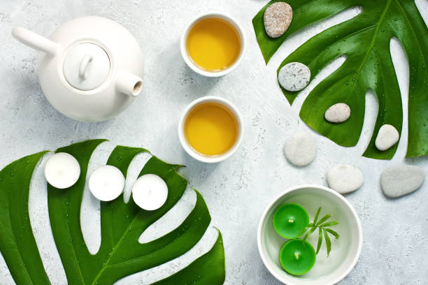 istock Green  tea and teapot  on  light surface. Top view 1153934682