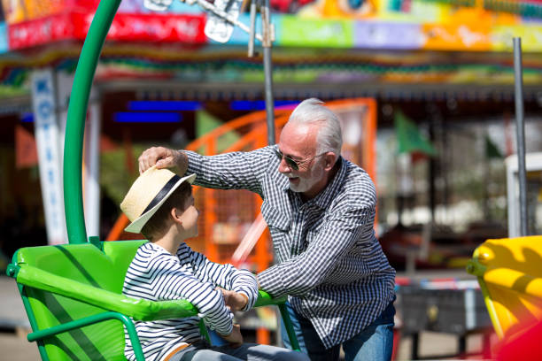 istock Grandfather and grandson amusement park fun 1153935808
