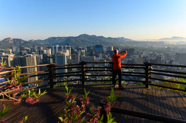 istock Man taking a selfie with the Seoul cityscape 1153935995