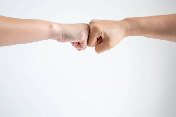 istock The fists bumping together on white background. 1153938698