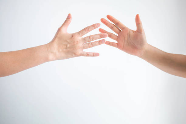istock Two teenager slapping hands together for greeting; or player touching hands for replace in sport game. 1153938702
