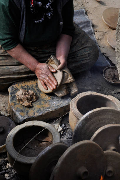 istock old woman doing earthen pots with her hands 1153938829
