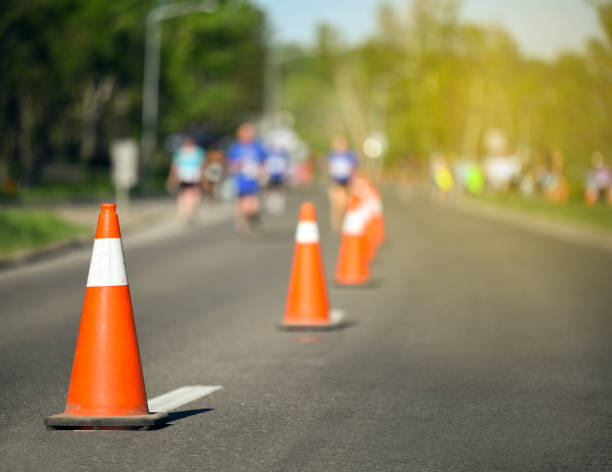 istock Pylon cones during a marathon with runners and yellow glow 1153943167